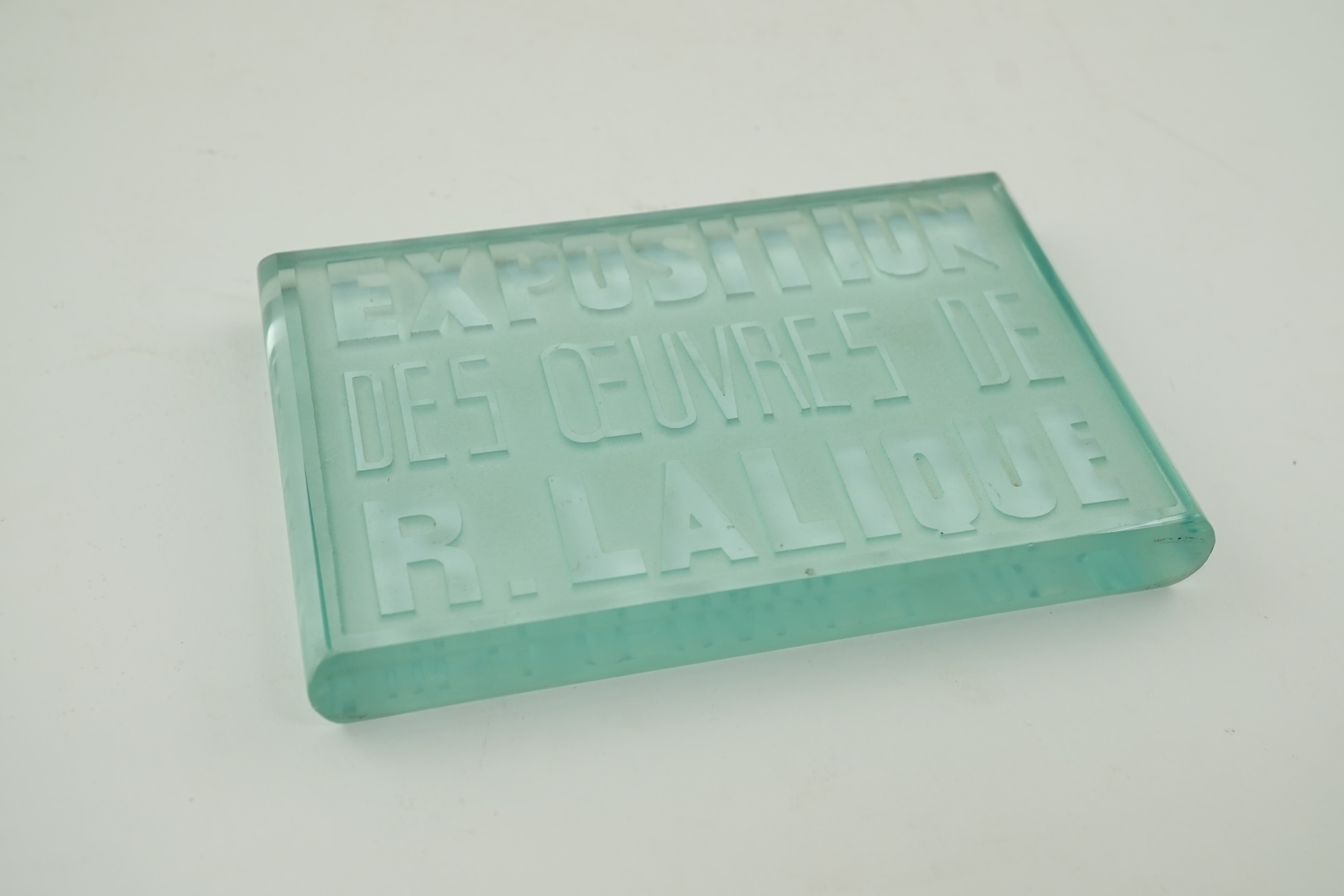 Lalique: A glass advertising plaque 'EXPOSITION DES ŒUVRES DE R.LALIQUE'